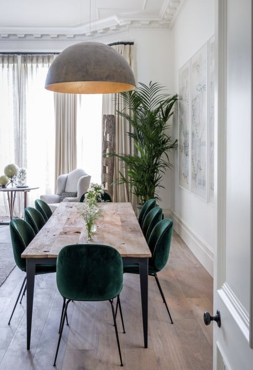 Green velvet dining room chairs around table